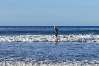 Costa Rica, Guanacaste, Playa Grande, Senior man surfing on sea wave