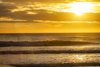 Costa Rica, Guanacaste, Playa Grande, Sun setting over calm sea