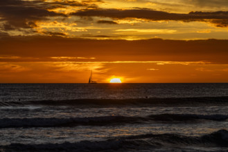 Costa Rica, Guanacaste, Playa Grande, Silhouette of sailboat on sea horizon at sunset
