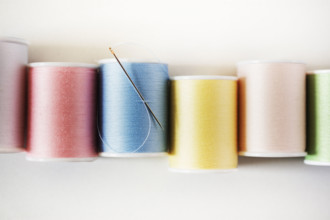 Studio shot of colorful spools of threads