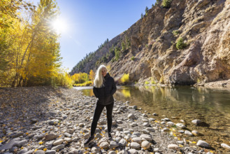 USA, Idaho, Bellevue, Portrait of senior blonde woman at river in autumn