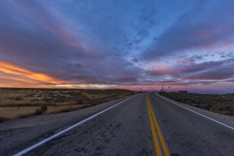 USA, Idaho, Boise, Dramatic sunrise sky above empty Interstate 84