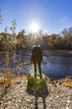 USA, Idaho, Bellevue, Rear view of woman facing Big Wood River on sunny autumn day