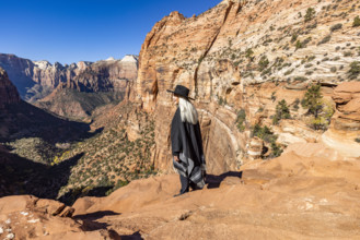USA, Utah, Zion National Park, Smiling woman in poncho and hat at Zion Canyon Overlook