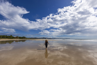 Costa Rica, Guanacaste, Playa Grande, Woman standing on empty beach