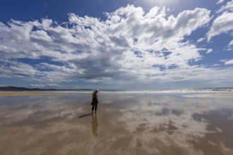 Costa Rica, Guanacaste, Playa Grande, Woman walking on empty beach