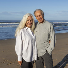 Costa Rica, Guanacaste, Playa Grande, Portrait of smiling senior couple on beach in morning