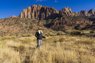 USA, Utah, Zion National Park, Female hiker in grassy field near