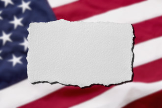 Torn paper with American flag background