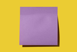 Blank purple post it note on yellow background