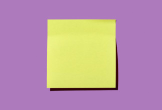 Blank yellow post it note on purple background