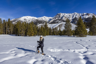 USA, Idaho, Sun Valley, Portrait of smiling woman snowshoeing on sunny winter day