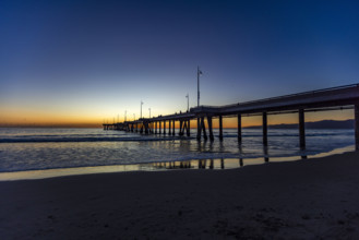 USA, California, Venice, Calm ocean and Venice Pier at sunset