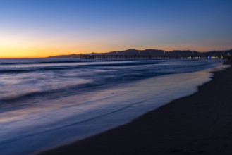 USA, California, Venice, Calm ocean and Venice Pier at sunset