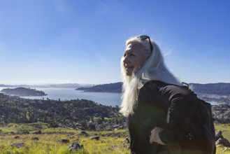 USA, California, Tiburon, Senior blond woman hiking Ring Mountain