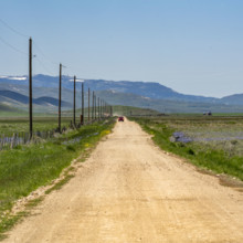 Empty dirt road crossing Camas Prairie. Fairfield, Idaho, USA.