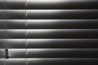 Close-up of window blinds with sunlight. New York City, New York State, USA.