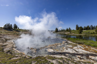 Hot spring emitting steam near Firehole River. , Wyoming, USA.