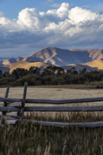 White puffy clouds over mountains and field. Bellevue, Idaho, USA.