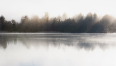 Morning mist on Mirror Lake. Lake Placid, New York State, USA.