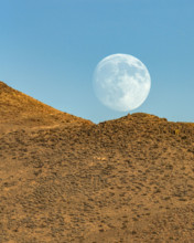 Moon rising over rocky hillside. Bellevue, Idaho, USA.