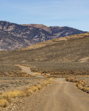 Empty rural dirt road over Trail Creek Pass. Mackay, Idaho, USA.