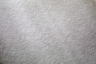 Dappled light on textured white paper. New York City, New York State, USA.