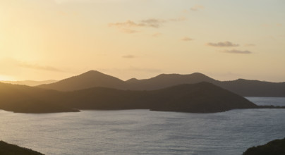 Calm ocean and mountains at sunrise. New York City, New York State, USA.