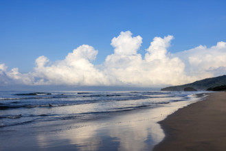 Sky and clouds reflecting in calm sea surface at dawn, Playa Grande, Guanacaste, Costa Rica.