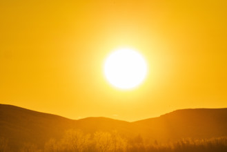 Sun setting over hills, Bellevue, Idaho, USA.