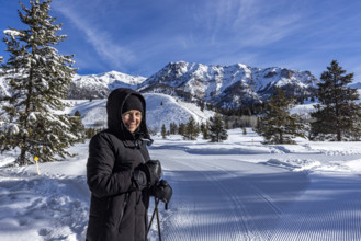 Portrait of smiling senior woman snowshoeing in Sun Valley, Sun Valley, Idaho, USA.