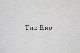 The End typed on white paper, New York City, New York, USA.