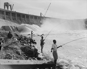 Fishing at the Owen Falls Dam. Men fishing at the site of the brand new Owen Falls Dam (Nalubaale
