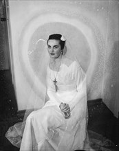 Georgina Fowler. Portrait shot of Georgina Fowler seated, wearing a wedding dress. Kenya, 16