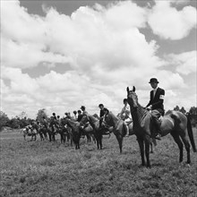 Kuwinda horse show. Seated riders in uniform line up to compete in the class 4 novice category of