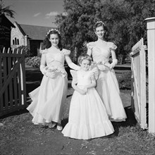 Three bridesmaids. Three bridesmaids at the Schofield-Sturman wedding pictured outside the entrance