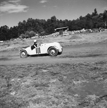 Number 101. An Anglia Special racing car driven by Zelda Hughes, competes in race number nine at