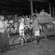 Eldoret prize-giving. An African boy with a bicycle receives congratulations from a European woman