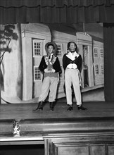 What a bore'. Wearing theatrical costume, Fred and Watson perform their 'What a bore' act on stage