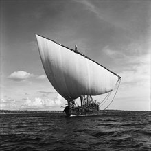 Dhow at sea. A small dhow sailing off the coast of Zanzibar (now Tanzania) in the Indian ocean.