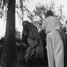 Woman at a cleansing ceremony. A woman at a cleansing ceremony, wrapped in cloth with her head