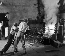 Sparks fly at a railway workshop. A publicity photograph from the East African Railways and