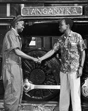 Julius Nyerere greets a train driver. A publicity photograph from the East African Railways and