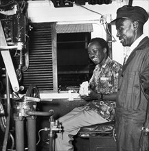 Julius Nyerere in train driver's seat. A publicity photograph from the East African Railways and