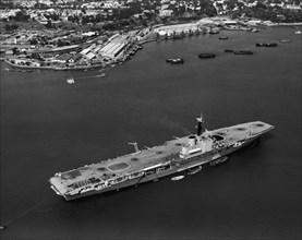 HMS Bulwark in Kilindini harbour. An aerial publicity photograph from the East African Railways and