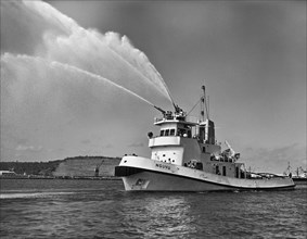 Port tug Nguvu firing water cannon. A publicity photograph from the Port Division of the East