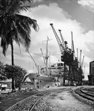 SS Kenya at Kilindini harbour. SS Kenya moored alongside the dockside railway and cranes in number