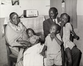 A 'modern' Maasai family. Portrait of a 'modern' Maasai family inside a home decorated with