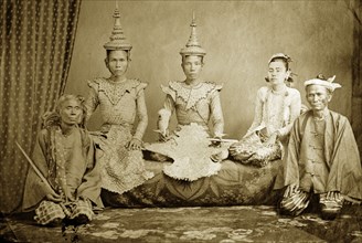 Burmese court performers. Studio portrait of a group of Burmese court performers and attendants,