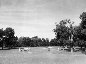 Golfers at Rangoon Golf Club. A group of golfers stroll to the next hole on the course at Rangoon